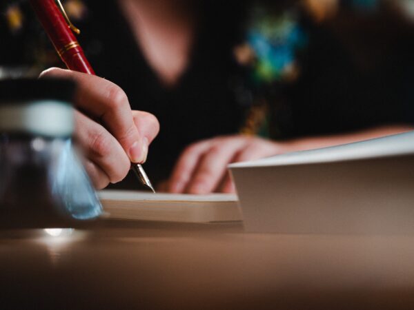 Closeup of a woman's hand writing with a pen