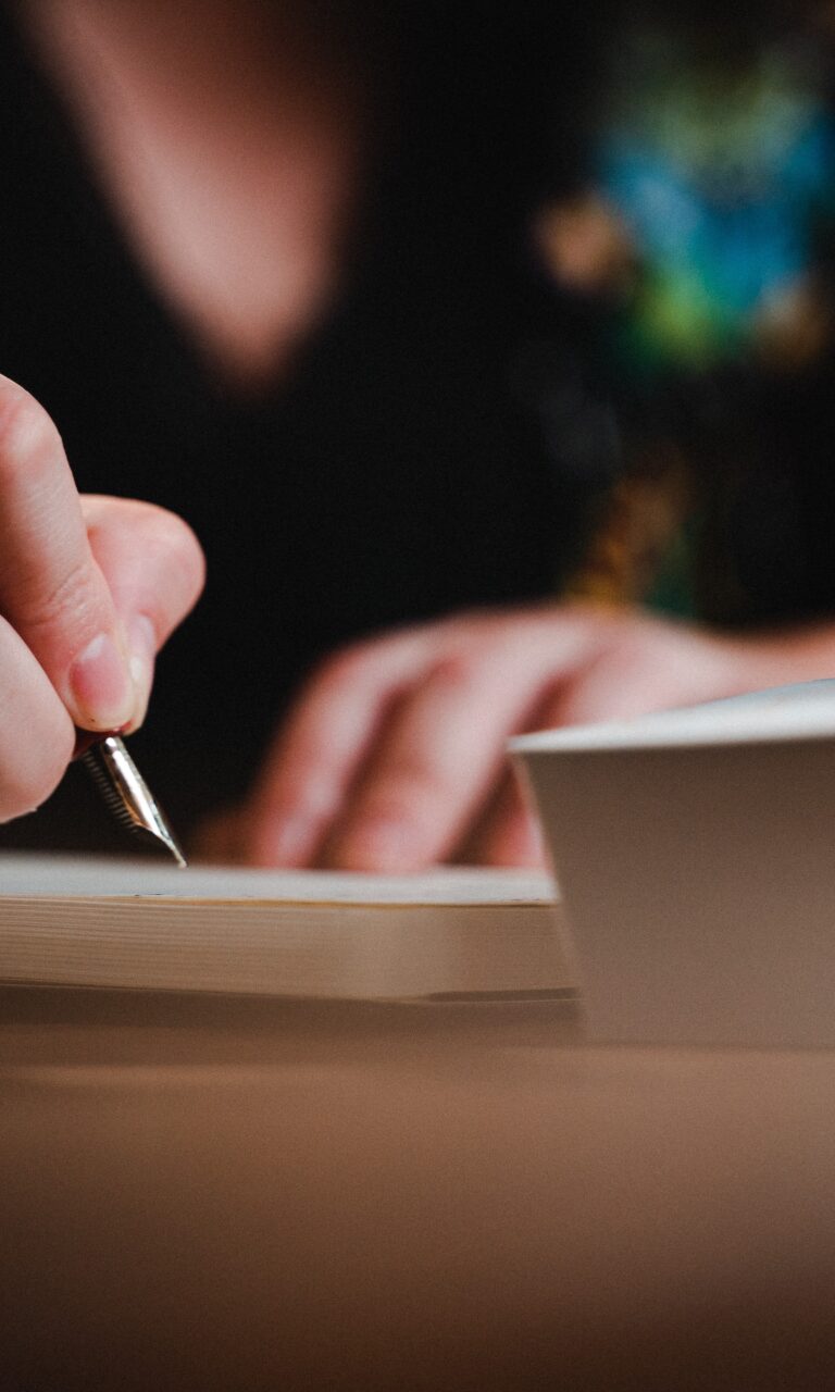 Closeup of a woman's hand writing with a pen