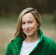 Photo of Emily Liebtag outside with a green jacket on.