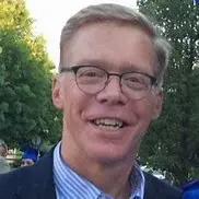 Photo of Jon Sappey with trees in the background, smiling at the camera.