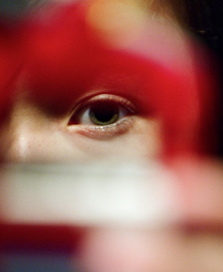 Young person peering through a cookie cutter into the camera lens