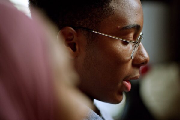 A boy with glasses reads a letter
