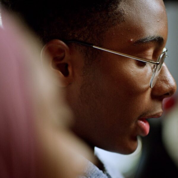 A boy with glasses reads a letter