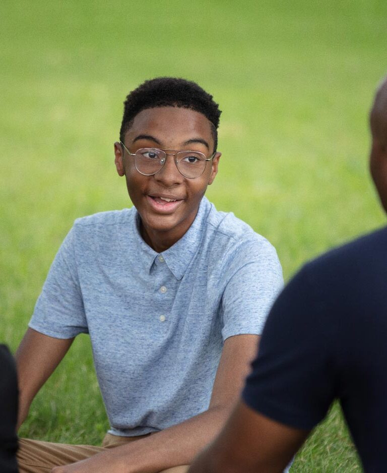 A teenage boy talks to his mom and dad