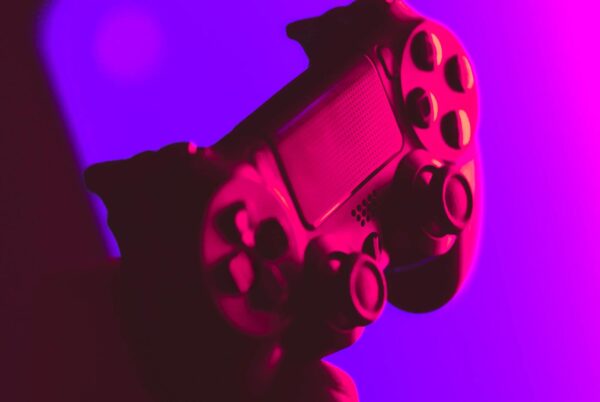 A game controller bathed in neon light