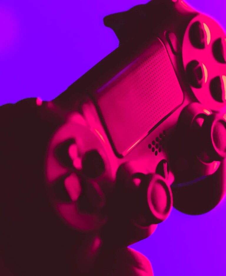 A game controller bathed in neon light