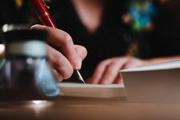 A woman journals with a fountain pen