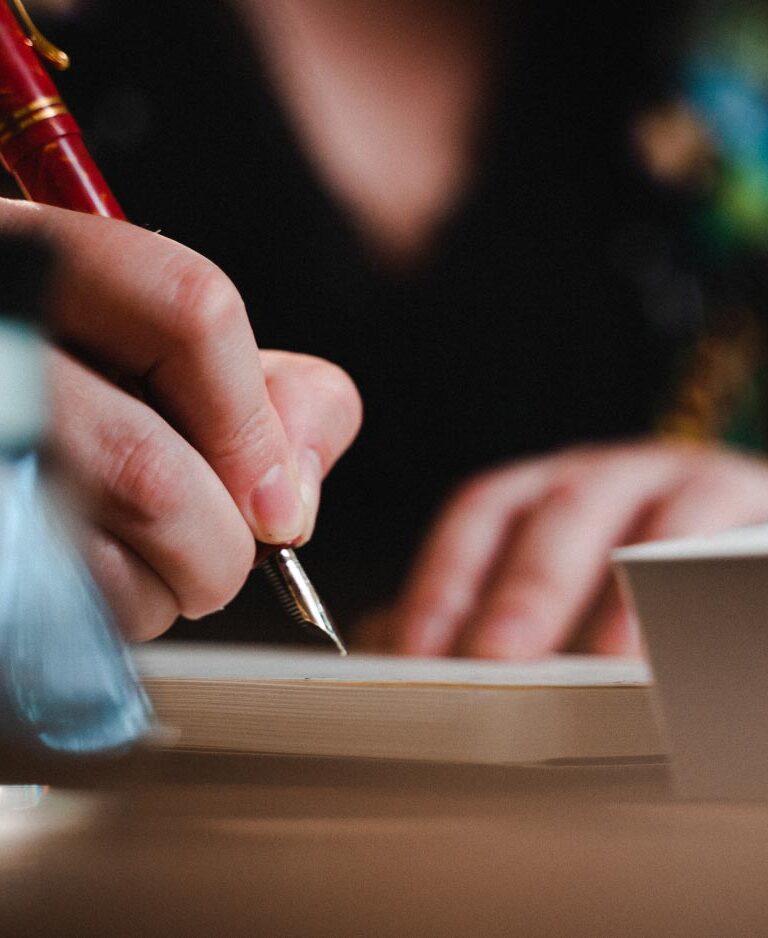 A woman journals with a fountain pen