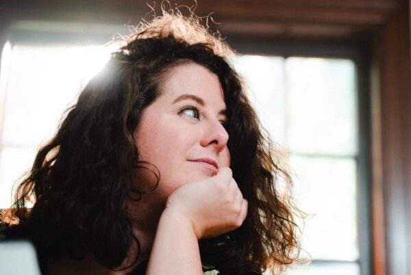 A closeup image of Annie Westphal, backlit by a sunny window.