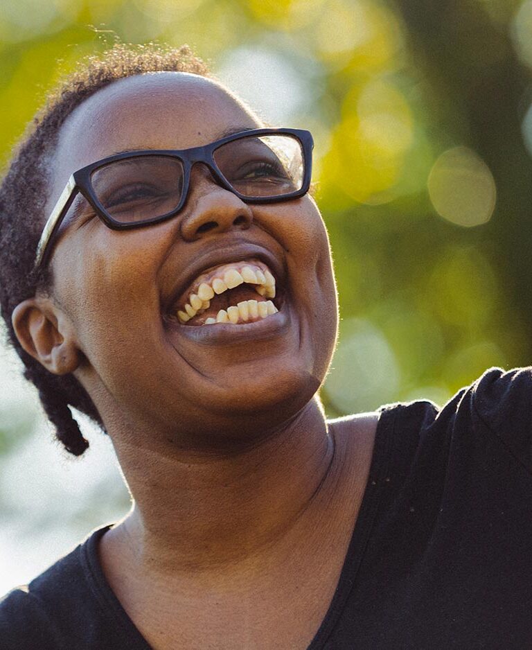 Closeup of Crystal Farmer looking up and smiling to someone off camera.