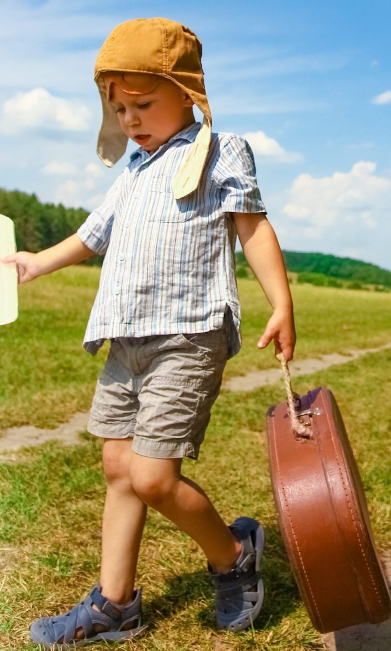Boy playing with toy plane outside